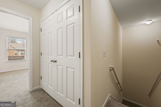 stairway featuring carpet and baseboards