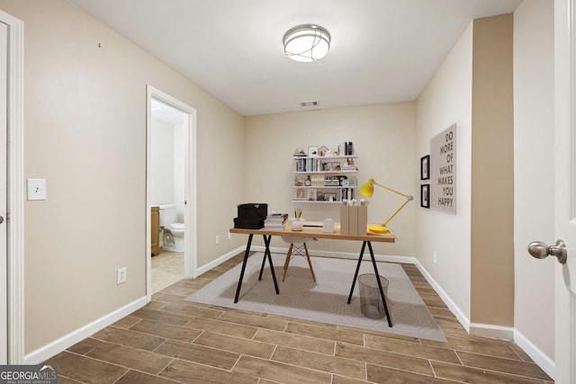 office space featuring wood tiled floor, visible vents, and baseboards