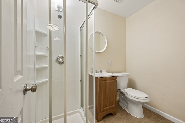 full bathroom featuring toilet, vanity, baseboards, a shower stall, and tile patterned floors