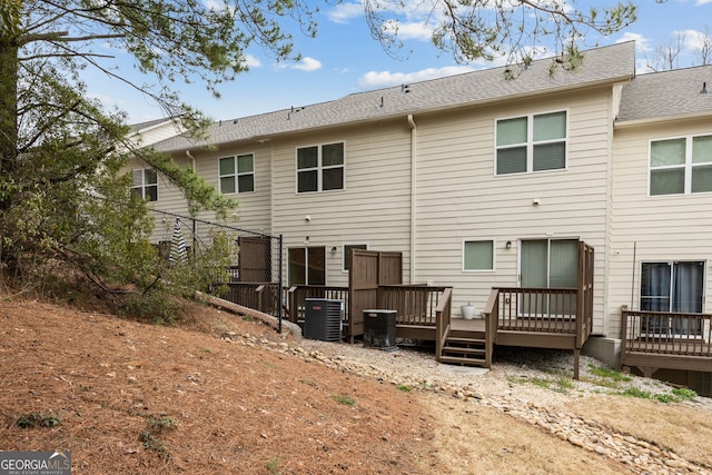 rear view of house featuring central AC and a deck