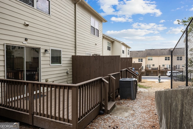 exterior space with a residential view, a deck, and central AC