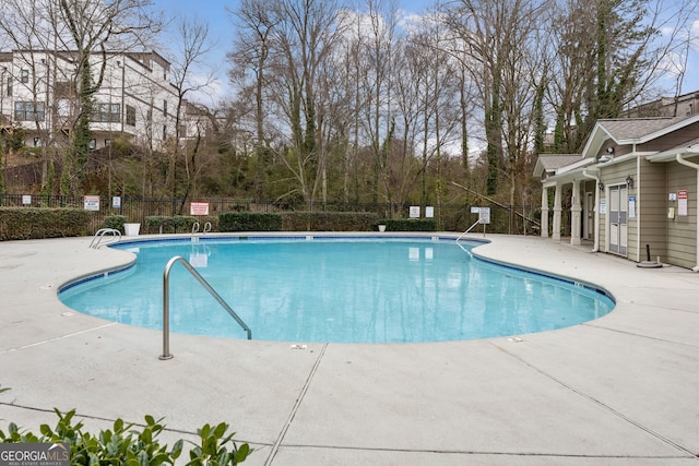 pool featuring a patio and fence