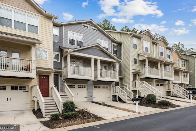 townhome / multi-family property featuring driveway and a garage