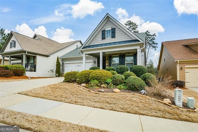 craftsman house with driveway, a standing seam roof, and a garage