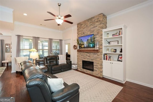 living room with dark wood-style floors, a fireplace, and crown molding