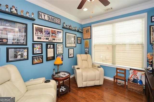 sitting room featuring baseboards, visible vents, ceiling fan, ornamental molding, and wood finished floors