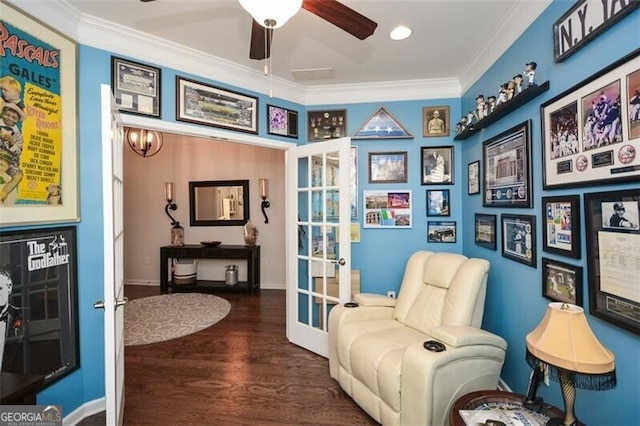 sitting room with french doors, ornamental molding, a ceiling fan, wood finished floors, and baseboards