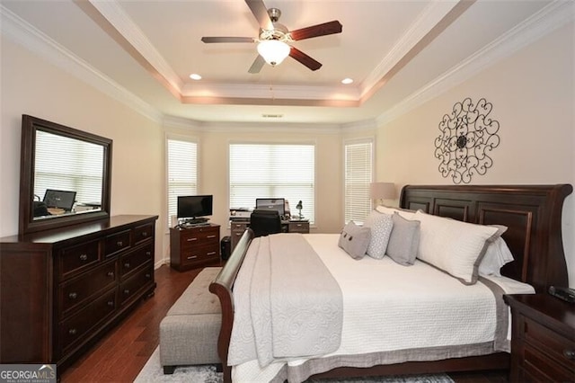 bedroom featuring crown molding, a raised ceiling, dark wood-style flooring, and recessed lighting