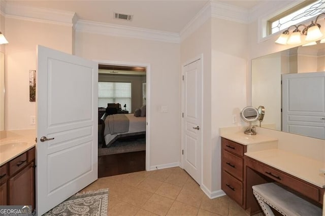 ensuite bathroom featuring connected bathroom, vanity, visible vents, tile patterned floors, and crown molding