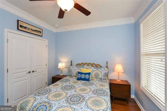 bedroom featuring a ceiling fan, baseboards, ornamental molding, and wood finished floors