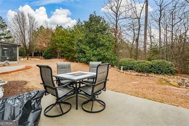 view of patio / terrace with outdoor dining area and a sunroom