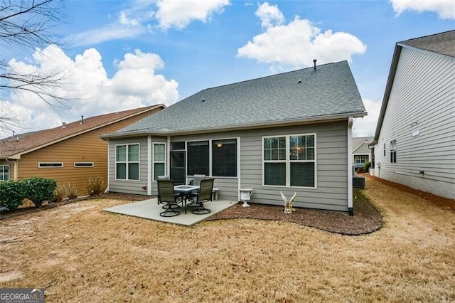 rear view of property featuring a patio, a yard, and roof with shingles