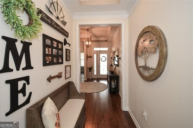 hall with baseboards, dark wood finished floors, crown molding, and a chandelier