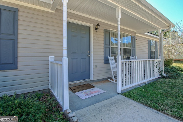 view of exterior entry featuring a porch