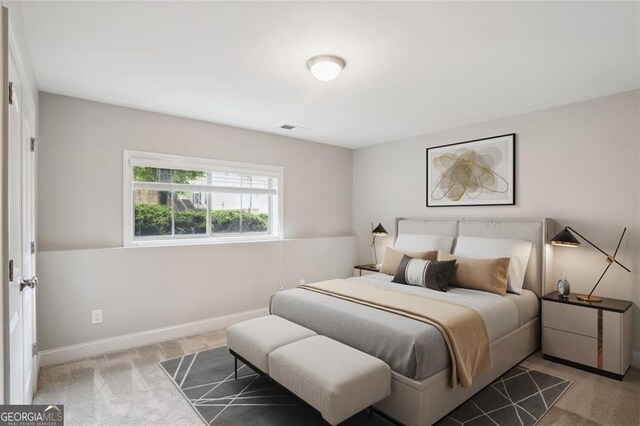 bedroom featuring visible vents, baseboards, and carpet