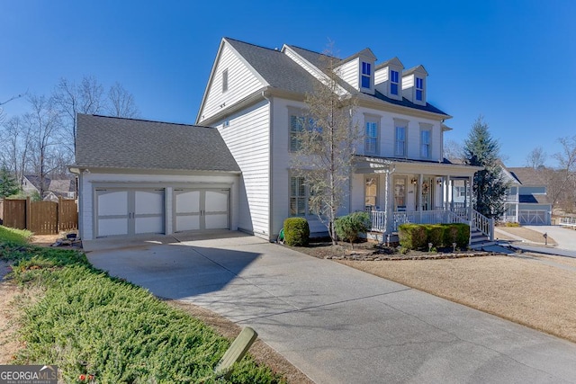 view of front of property with covered porch, a garage, a shingled roof, fence, and driveway