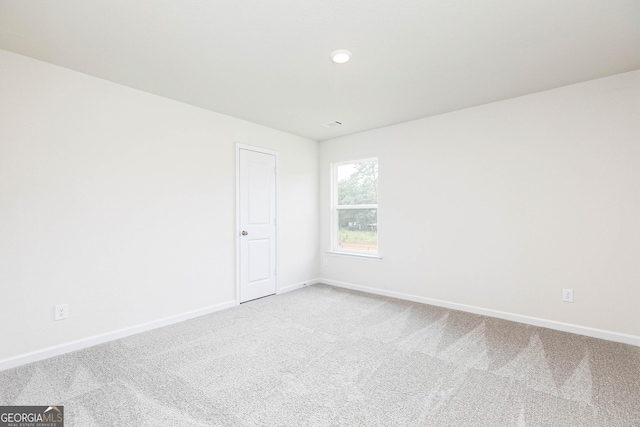 empty room with carpet floors and baseboards