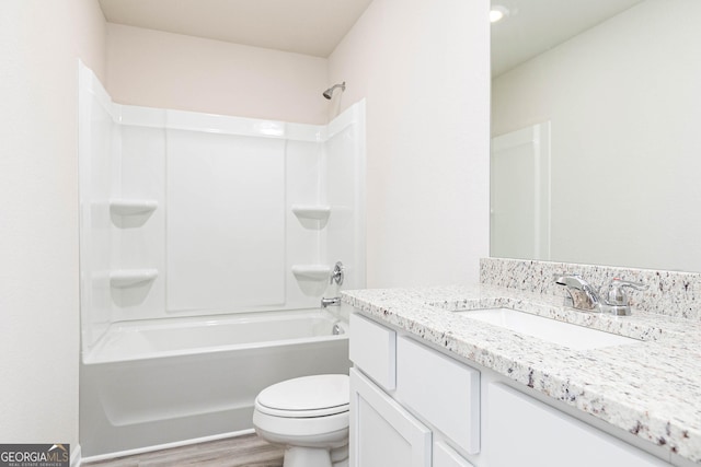 bathroom featuring vanity, bathtub / shower combination, wood finished floors, and toilet