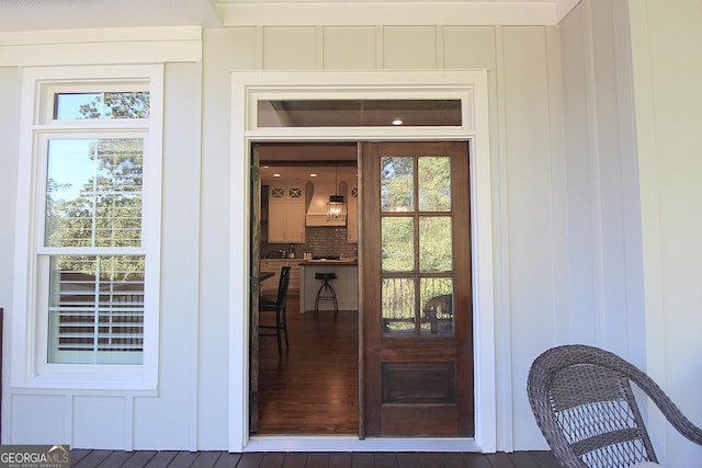 view of exterior entry with board and batten siding