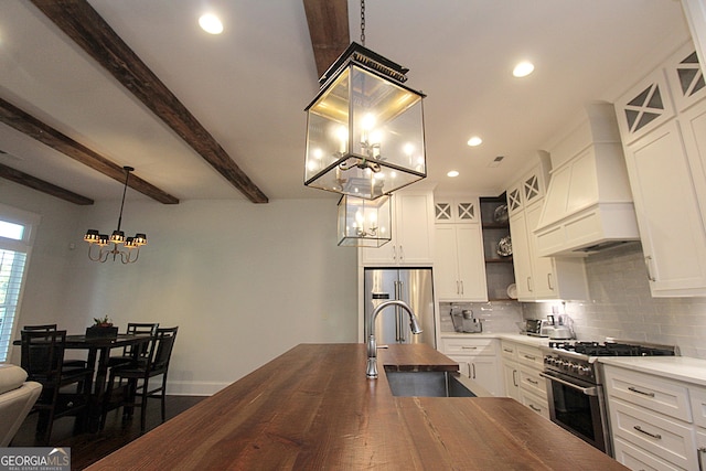 kitchen featuring custom exhaust hood, tasteful backsplash, appliances with stainless steel finishes, a sink, and wood counters