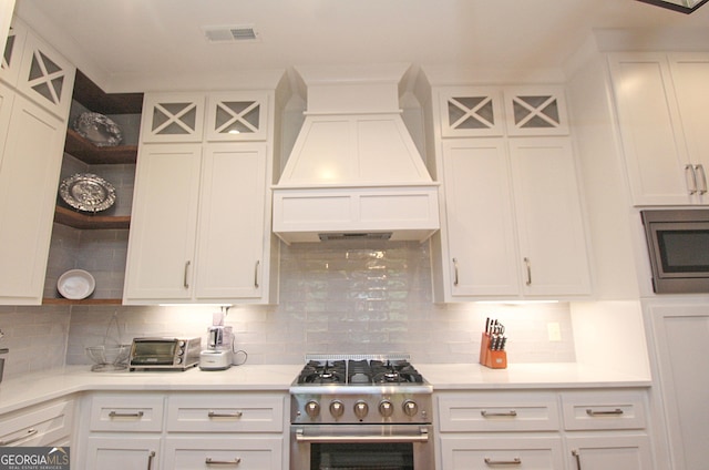 kitchen featuring visible vents, white cabinets, appliances with stainless steel finishes, premium range hood, and open shelves