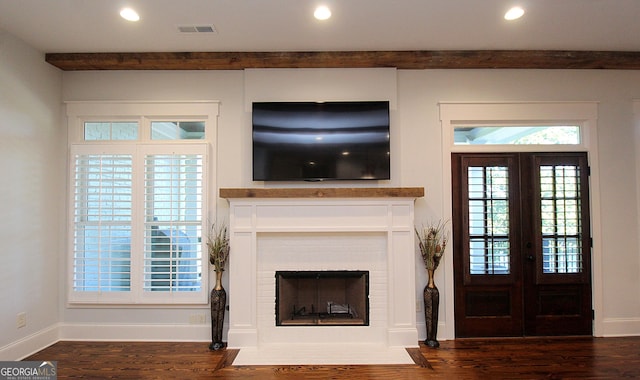 unfurnished living room featuring dark wood-style flooring, a fireplace, recessed lighting, visible vents, and baseboards