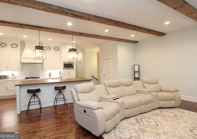 living room featuring dark wood-style floors, baseboards, beam ceiling, and recessed lighting