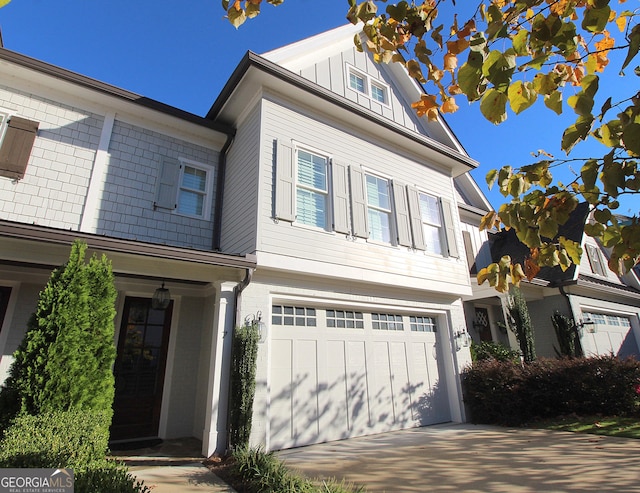 view of front of property featuring a garage, board and batten siding, and concrete driveway