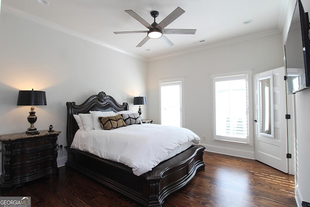 bedroom with crown molding, multiple windows, visible vents, and wood finished floors