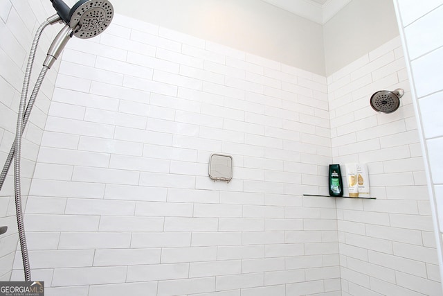 full bath with crown molding and a shower stall