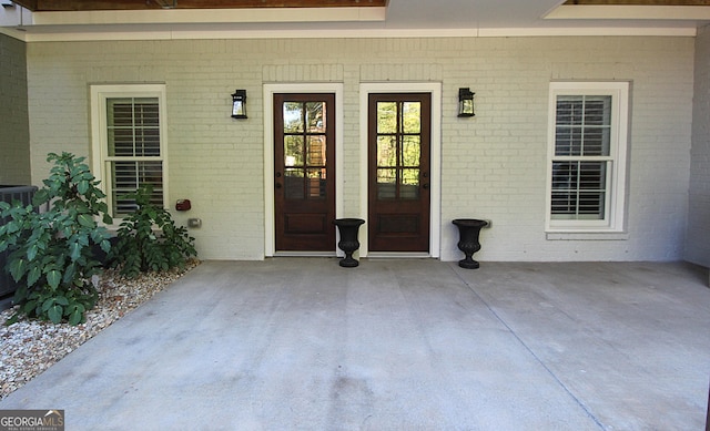 entrance to property featuring brick siding