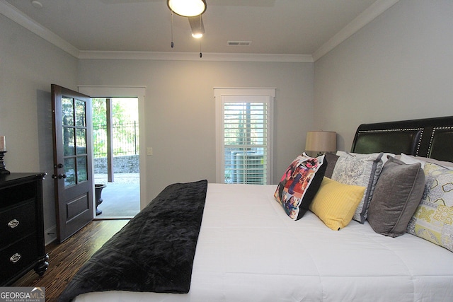 bedroom featuring access to exterior, visible vents, dark wood-style floors, and ornamental molding