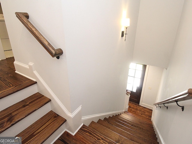 stairs with baseboards and wood finished floors