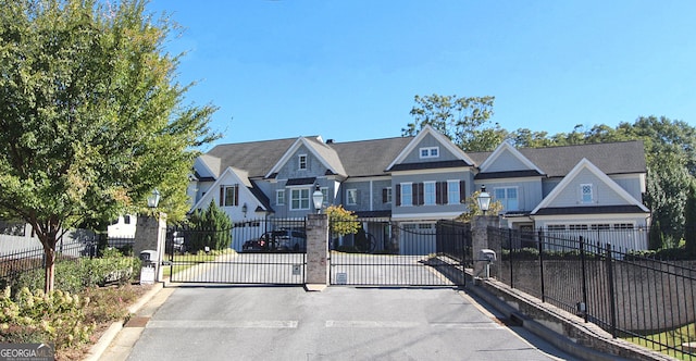 view of front of house featuring a residential view, a gate, and fence