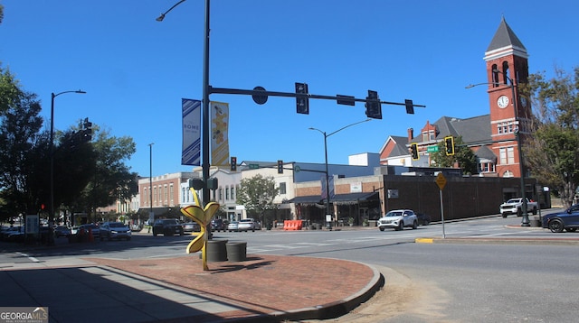 view of road with street lighting, traffic signs, curbs, and sidewalks