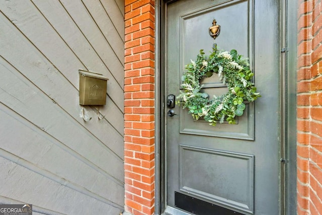 doorway to property with brick siding