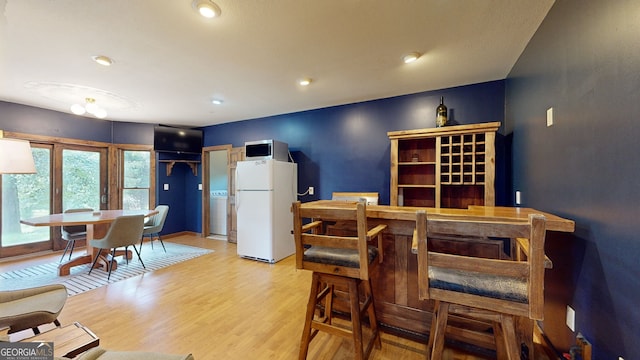 dining space featuring light wood finished floors and recessed lighting