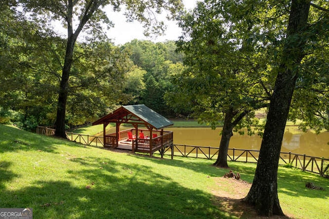 surrounding community featuring fence, a lawn, and a gazebo