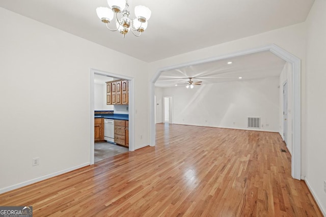 unfurnished living room featuring light wood-style floors, baseboards, visible vents, and ceiling fan with notable chandelier