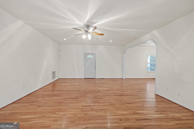 unfurnished living room featuring baseboards, light wood-style flooring, visible vents, and a ceiling fan