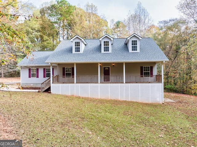 cape cod home featuring a shingled roof, covered porch, and a front lawn