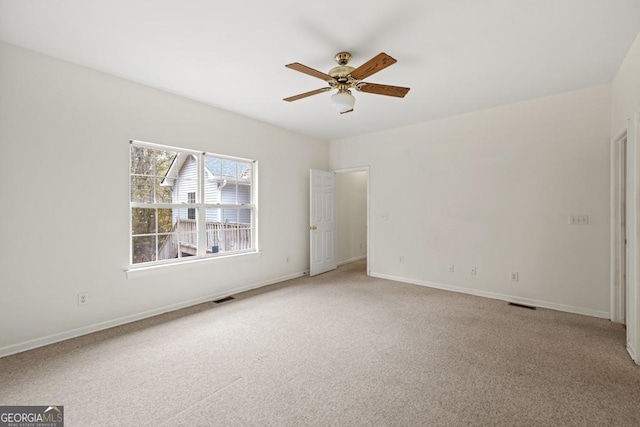 spare room with a ceiling fan, baseboards, visible vents, and carpet flooring