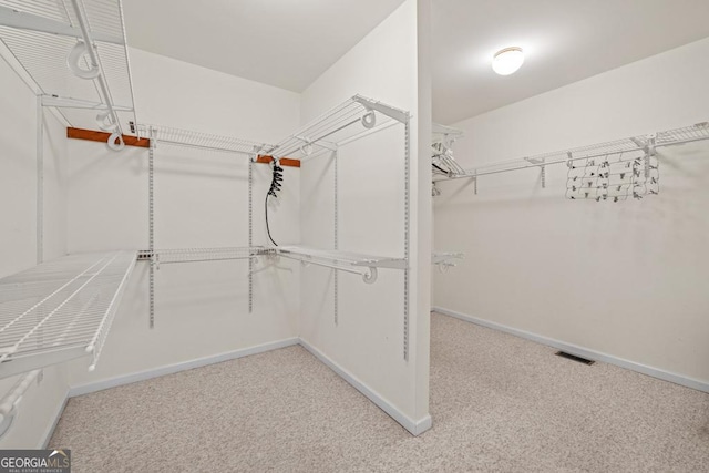 spacious closet with carpet and visible vents