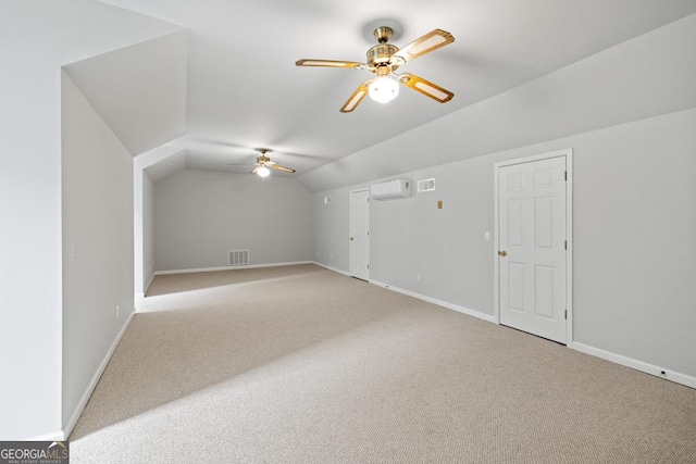 bonus room featuring baseboards, a ceiling fan, light colored carpet, lofted ceiling, and a wall mounted AC