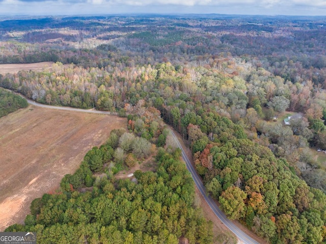 birds eye view of property featuring a view of trees