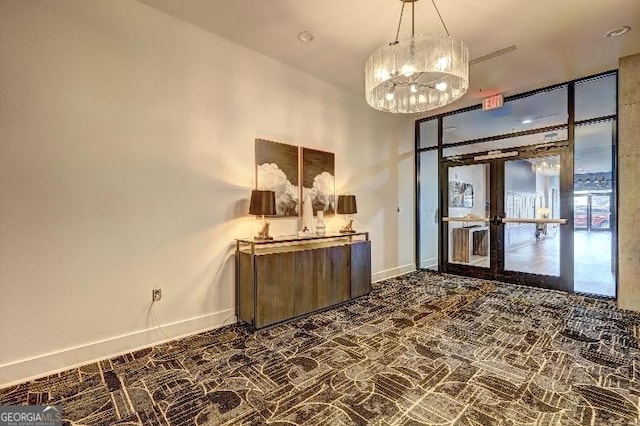 interior space with a notable chandelier, french doors, and baseboards