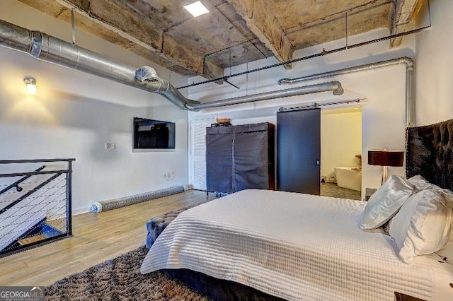 bedroom featuring baseboards and wood finished floors