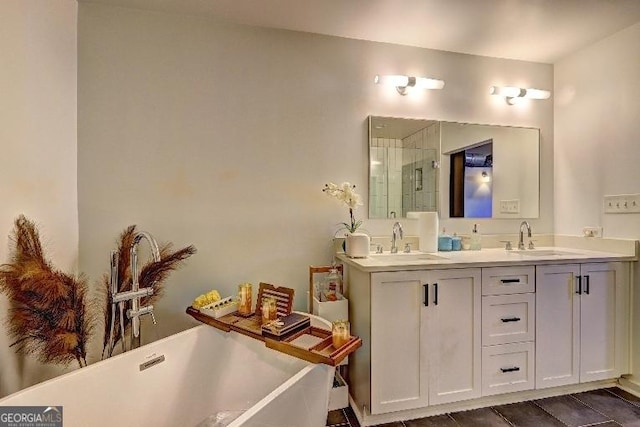 bathroom with double vanity, a soaking tub, a shower with door, and a sink