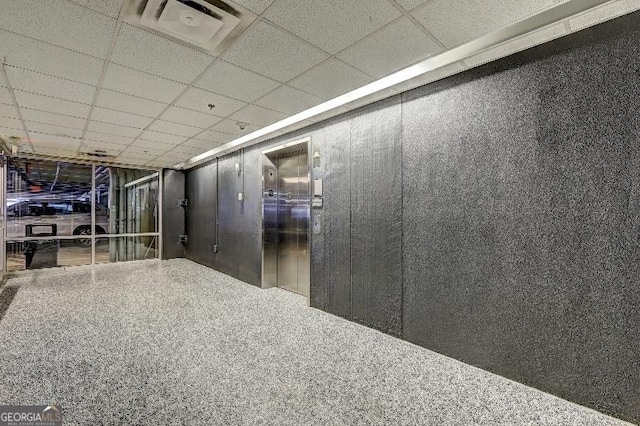 interior space with visible vents and a paneled ceiling