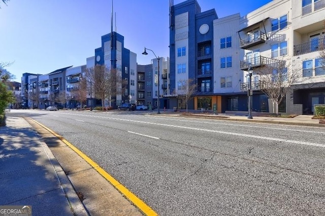 view of road with sidewalks, curbs, and street lighting